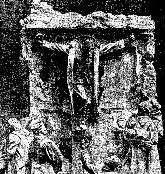 Canada\'s Golgotha sculpture showing a soldier fixed to a stone wall, with several uniformed figures looking up below him.
