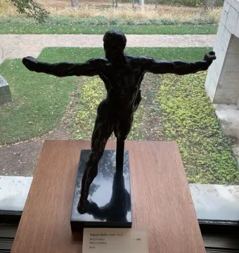 Standing Mercury bronze sculpture of a muscular male figure in a dynamic mid-stride pose