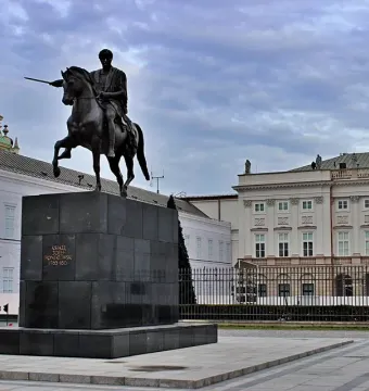 Prince Józef Poniatowski Monument, a dark equestrian statue on a tall stone pedestal in a paved square.