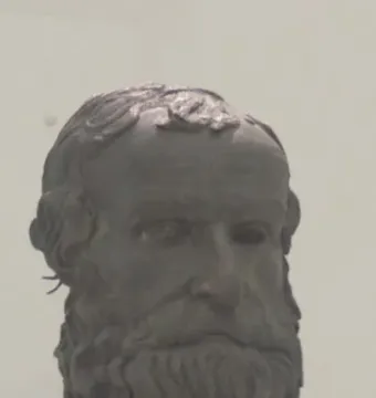 Bronze head of the Porticello Philosopher with curly beard and hollow eyes