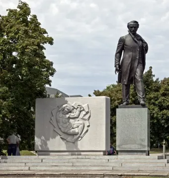 Taras Shevchenko Memorial with a bronze statue beside a relief stele on a tiered stone base.
