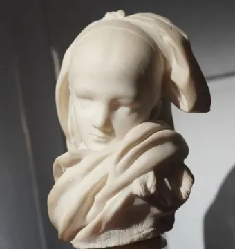 Alsatian Orphan sculpture displayed indoors during museum renovations.