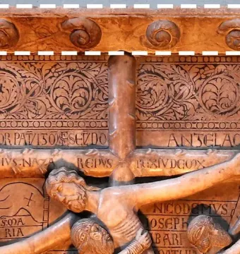 Detail of Benedetto Antelami\'s Descent from the Cross marble relief, showing figures around the cross with an ornate frieze above.