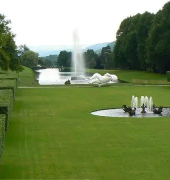 Emperor Fountain with a tall water jet in a park landscape