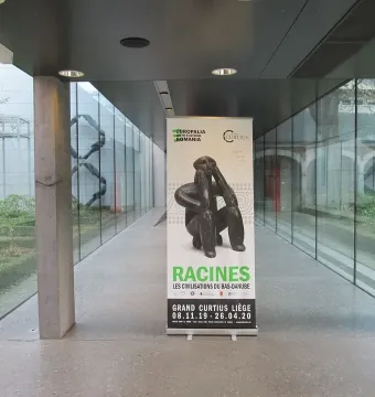 Banner showing The Thinker of Cernavodă in a contemplative seated pose inside a modern hallway.