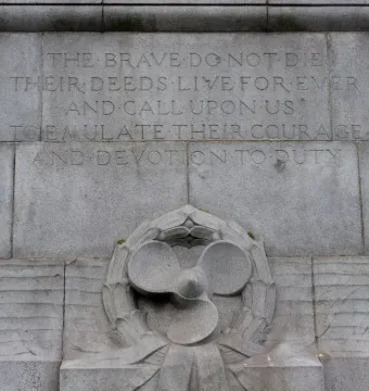 Titanic Engine Room Heroes Memorial inscription with carved male figures and a propeller wreath relief.