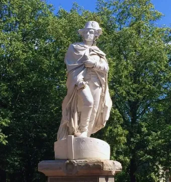 George Washington marble statue in military attire standing on a pedestal