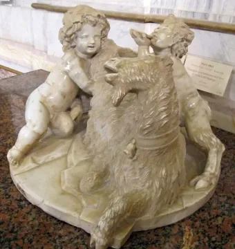 The Goat Amalthea marble sculpture with a shaggy goat lying down and two cherubic figures beside it.