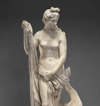 Mazarin Venus, a standing carved female figure beside a dolphin on a textured base.