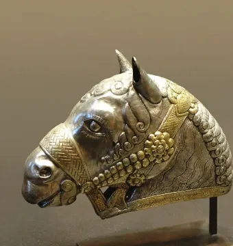 Sassanian horse head sculpture in gilded silver with detailed decorative patterns