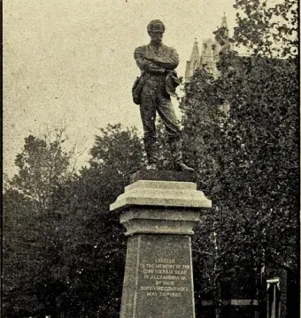 The Appomattox statue shows a man in a military uniform standing with his arms crossed on a tall stone pedestal.