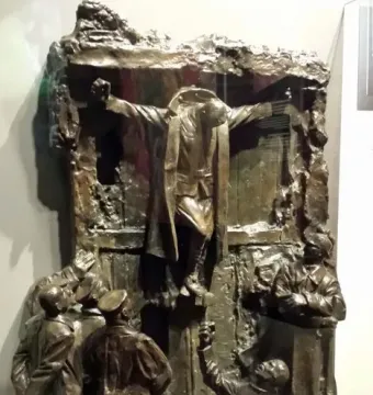 Canada\'s Golgotha bronze sculpture showing a central figure with outstretched arms above several uniformed figures looking up