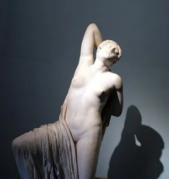 Niobid from the Gardens of Sallust, a white marble statue of a kneeling semi-nude woman with one arm raised behind her head.