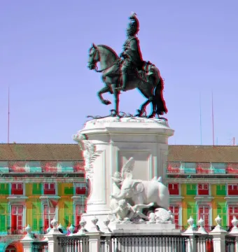 Equestrian Statue of Joseph I on a tall ornate pedestal with sculpted details, including an elephant, in front of a colorful building.