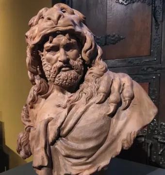 Bust of Hercules showing a bearded man with curly hair and an animal-skin headdress