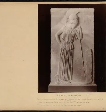 Stone relief of Mourning Athena, shown with her head bowed and leaning on a spear beside a rectangular stele.
