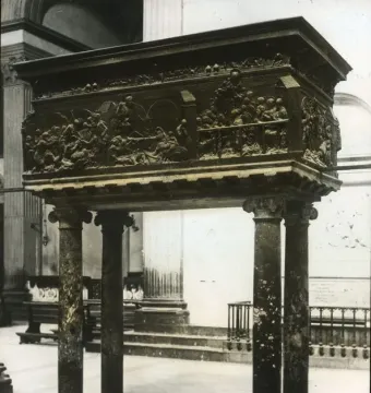 The Resurrection Pulpit, a bronze church pulpit with sculpted reliefs supported by marble columns inside San Lorenzo.