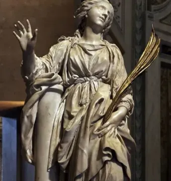 St Bibiana by Bernini, a marble statue of a female figure in flowing robes holding a palm frond.