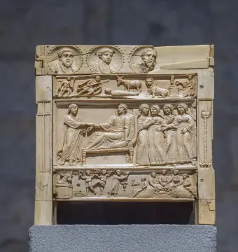 Brescia Casket ivory panel with carved relief scenes in horizontal registers, including busts, animals, and grouped figures.