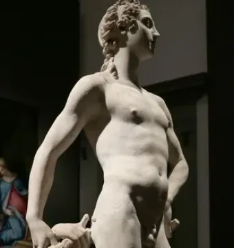 Apollo and Hyacinth in white marble, showing a standing figure beside a kneeling figure looking upward.