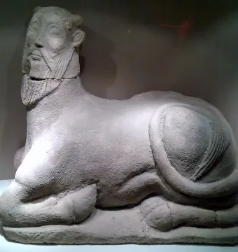 Bicha of Balazote stone sculpture with a human head and reclining animal body