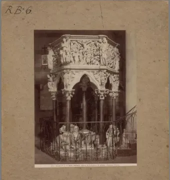 Sant\' Andrea Pulpit with ornate carved relief panels, columns, and supporting figures.