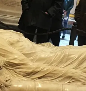 The Veiled Christ marble sculpture showing a reclining figure covered by a finely carved translucent-looking veil.