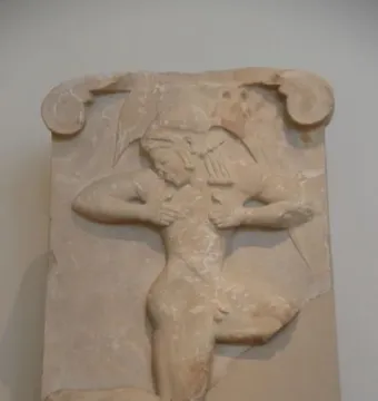 Runner Relief carved on a pale stone stele with a figure shown in profile in rapid motion.
