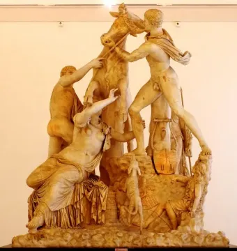 The Farnese Bull marble sculpture showing a dramatic scene with two men struggling to subdue a bull and a female figure beneath it.