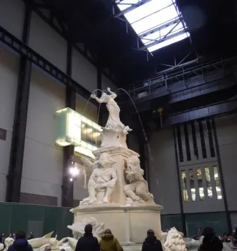 Fons Americanus fountain sculpture in Tate Modern’s Turbine Hall with visitors gathered around it