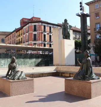 Goya Memorial with bronze statues and a taller monument in a city square