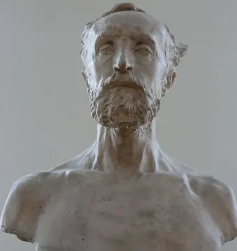 Light-toned bust of Jules Dalou with a prominent beard and mustache.