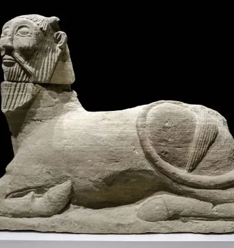 Bicha of Balazote stone sculpture with a bearded human head and reclining animal body