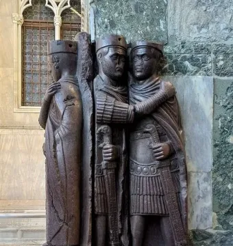 Portrait of the Four Tetrarchs, a dark reddish-purple porphyry sculpture of four stylized figures embracing in two pairs.