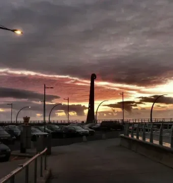 The Blackpool High Tide Organ silhouetted against a dramatic sunset sky on the promenade.