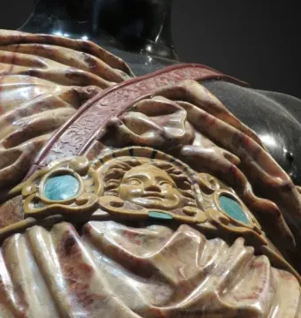 Moor of Borghese torso detail with sculpted drapery and a decorative strap featuring a face medallion.