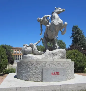 The Torch Bearers sculpture showing a rearing horse with a mounted figure and another figure reaching upward from the base.