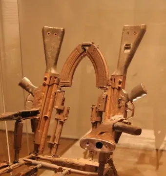 Throne of Weapons sculpture made from rusty gun parts and rifle stocks