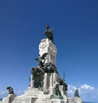 Antonio Maceo Monument with a bronze equestrian statue on a tall stone base decorated with bronze reliefs and figures.