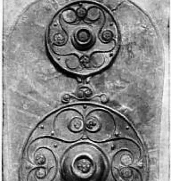Battersea Shield with three ornate circular bosses and intricate metalwork along its length.