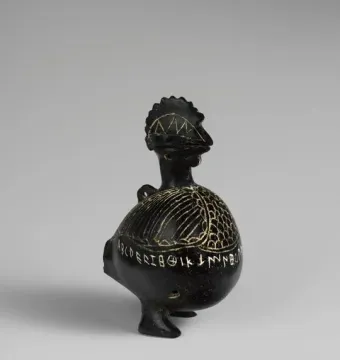 Viterbo Rooster ceramic vessel shaped like a rooster, with etched patterns and inscriptions around its body.