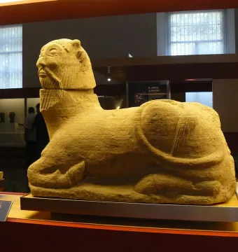 Bicha of Balazote stone sculpture with a human head and animal body in a museum display