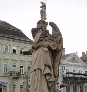 Angel statue on the Immaculata Marian Column with the Virgin Mary above it