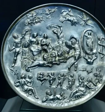 Parabiago Plate with a circular relief of mythological figures, including a central chariot drawn by lions.