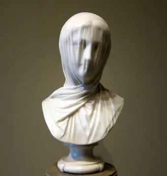 The Veiled Nun marble bust with a translucent veil draped over the woman’s face and shoulders.