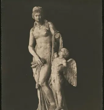 Venus Felix sculpture with a standing draped woman holding a flower beside a winged child.
