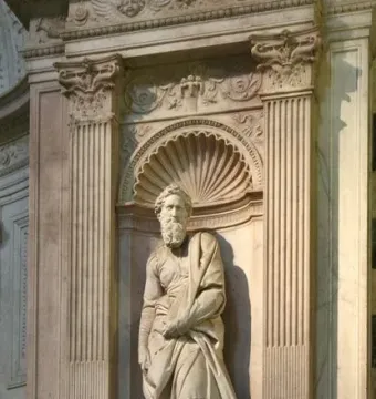 Saint Paul marble statue standing in an ornate carved niche with fluted pilasters and a shell-shaped alcove.