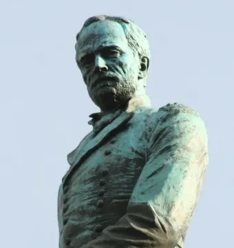 Sherman Monument bronze bust of a bearded man in military uniform against a blue sky