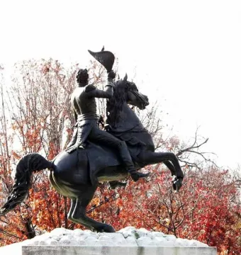 Andrew Jackson equestrian statue with the rider raising a hat overhead on a rearing horse.