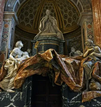 Tomb of Pope Alexander VII with a kneeling papal figure, draped marble curtain, and allegorical statues in St. Peter’s Basilica